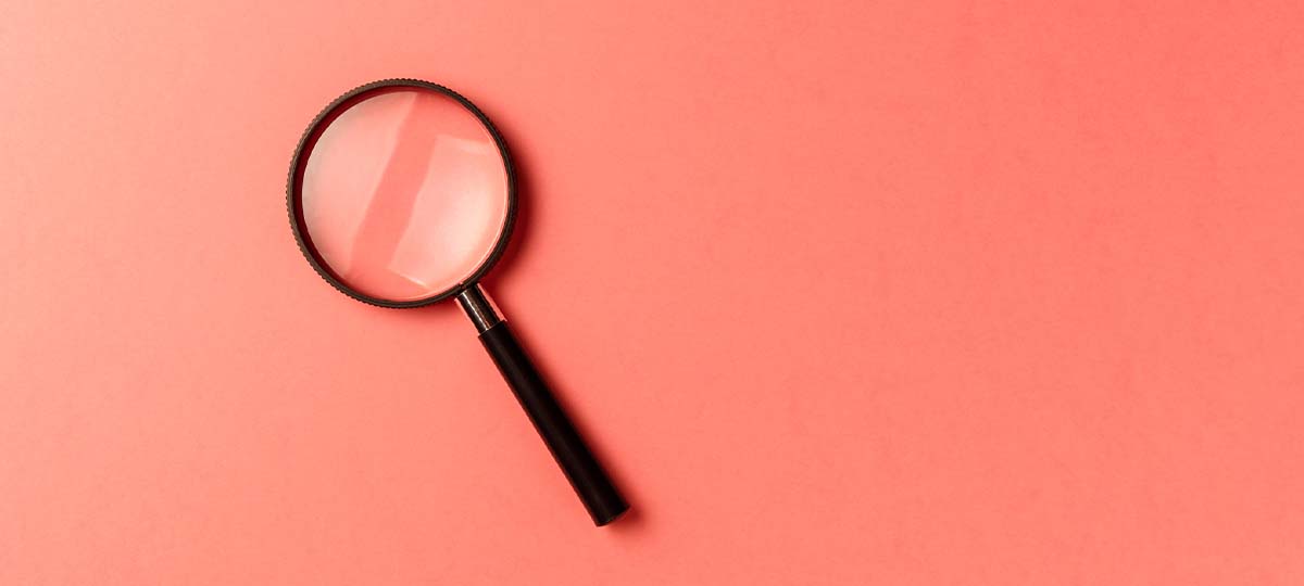 Magnifying glass with pink background