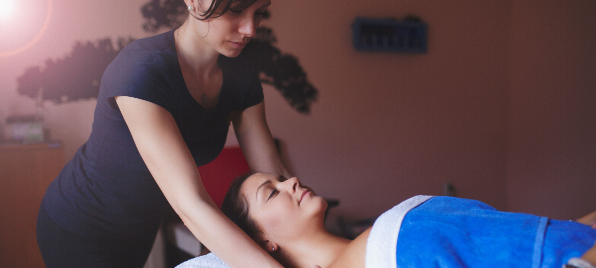 massage therapist massaging client's shoulders