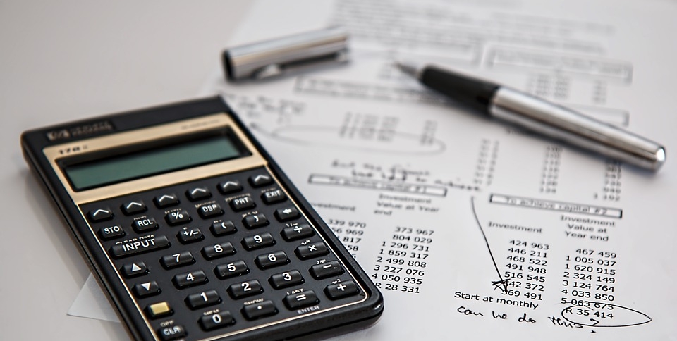 an image of a calculator and papers.