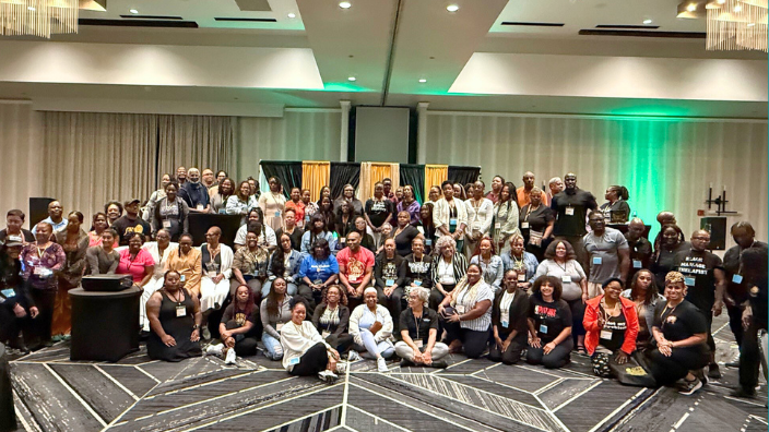 An image of a large group smiling.