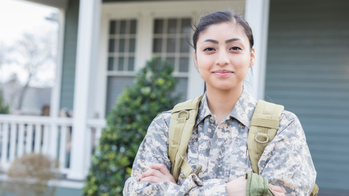 An image of a female veteran smiling at the camera.