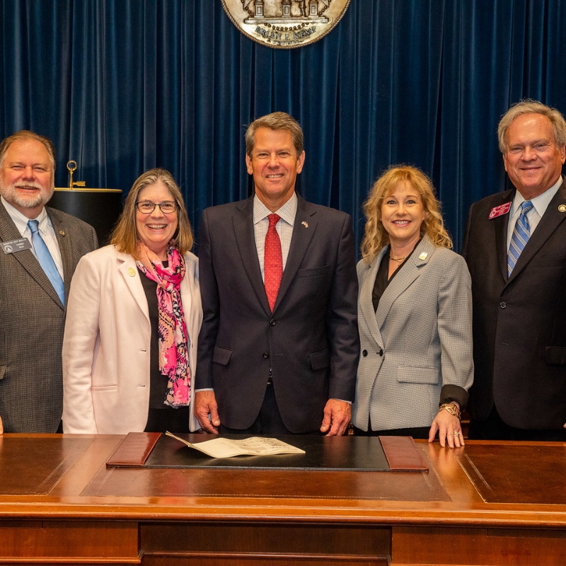 an image of a group of people smiling with the Georgia governor.