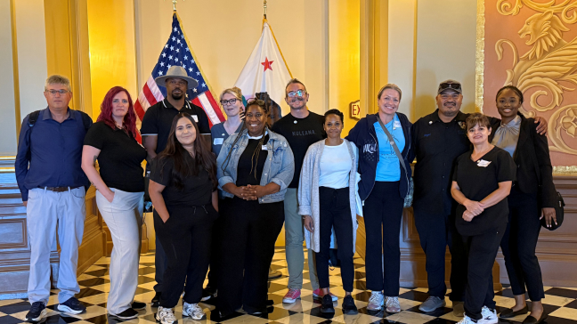 an image of a group of people smiling in a government building.
