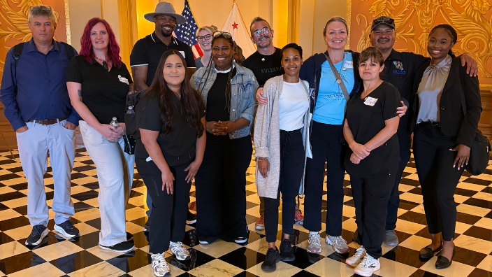 a group of people smiling in a government building.