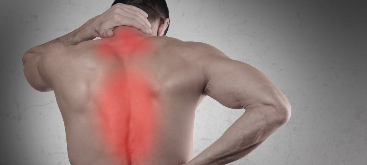 an image of a man touching the back of his neck in pain, the anatomical spine is highlighted in red to emphasize pain.