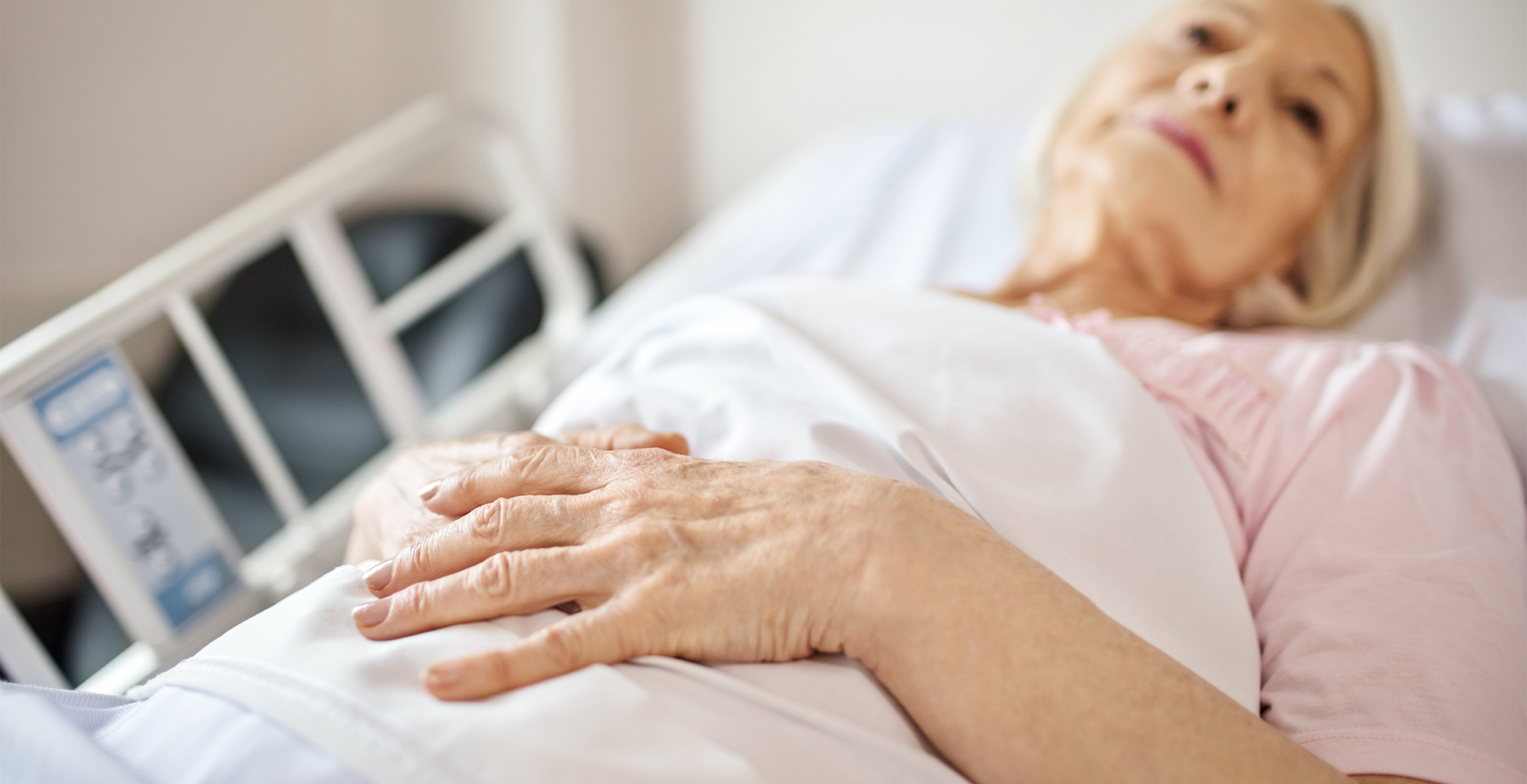 female patient lying in hospital bed