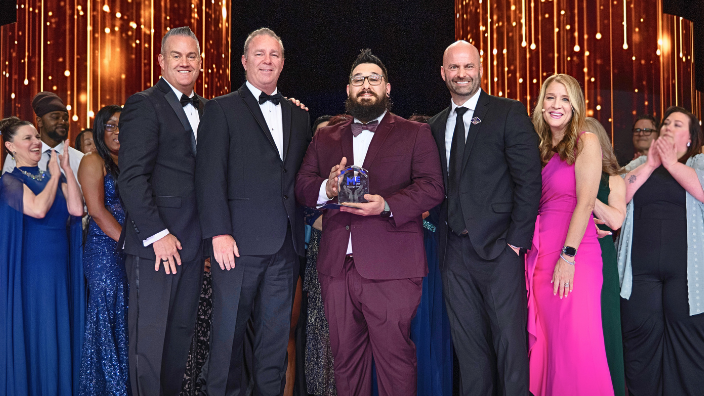 an image of John Nappi III receiving the Massage Envy 2025 Therapist of the Year Award.