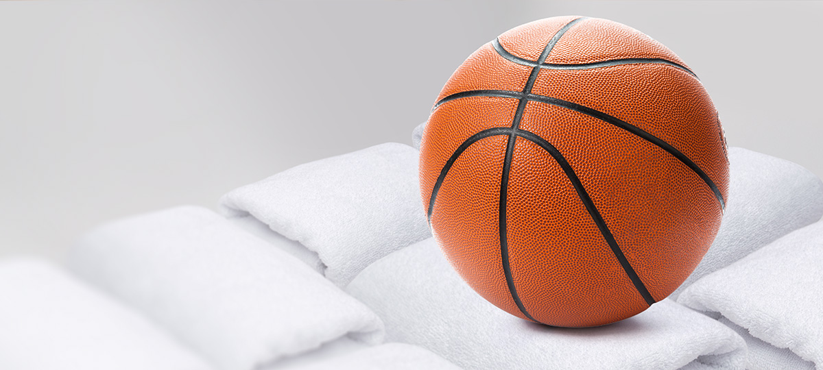 an image of a basketball next to folded towels.