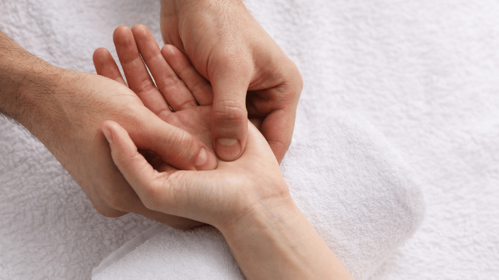 massaging client's hand