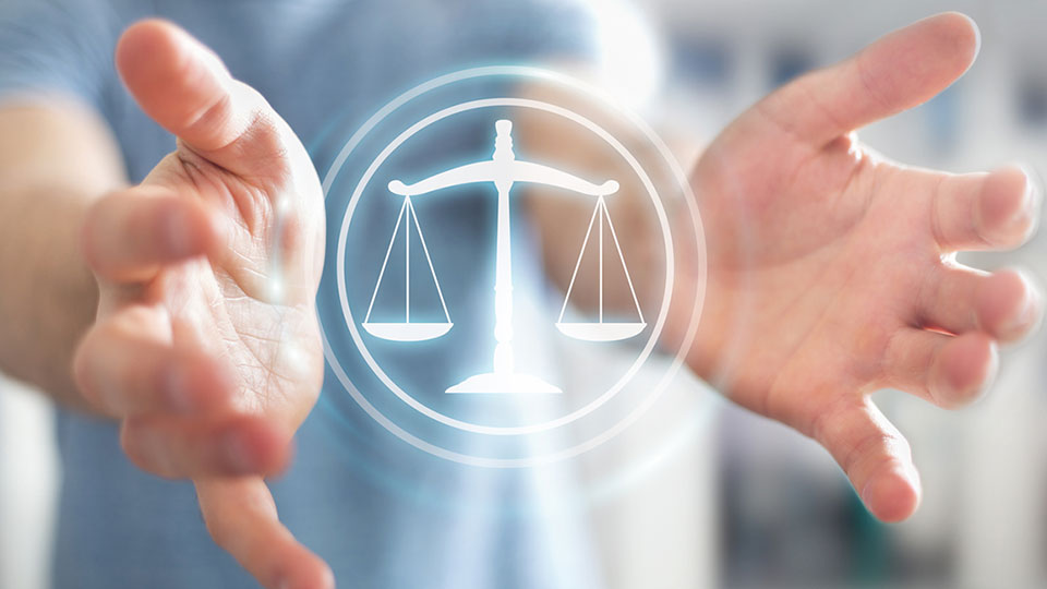 hands around scales of justice