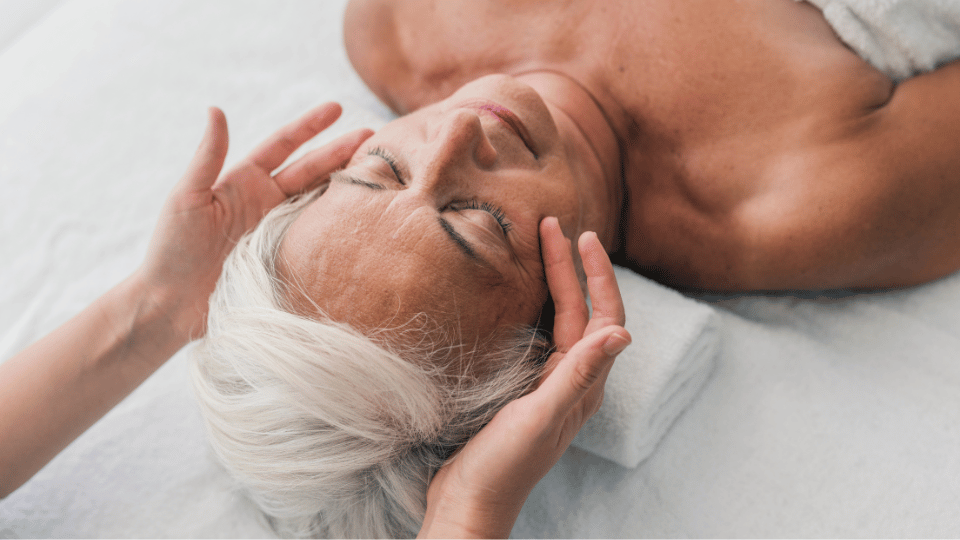 older woman receiving head massage