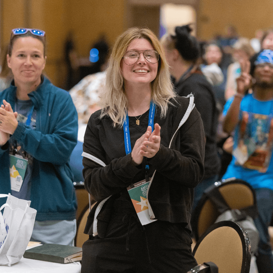 Student standing and clapping at Student Day