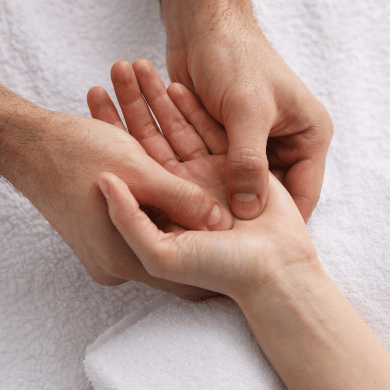 massaging client's hand