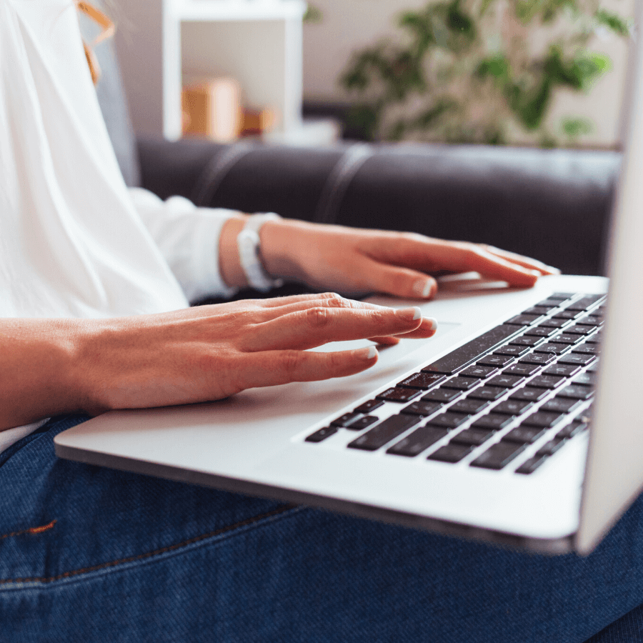 woman's hands typing on laptop