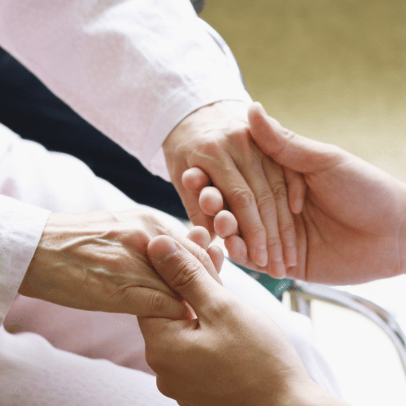 person holding patient's hands