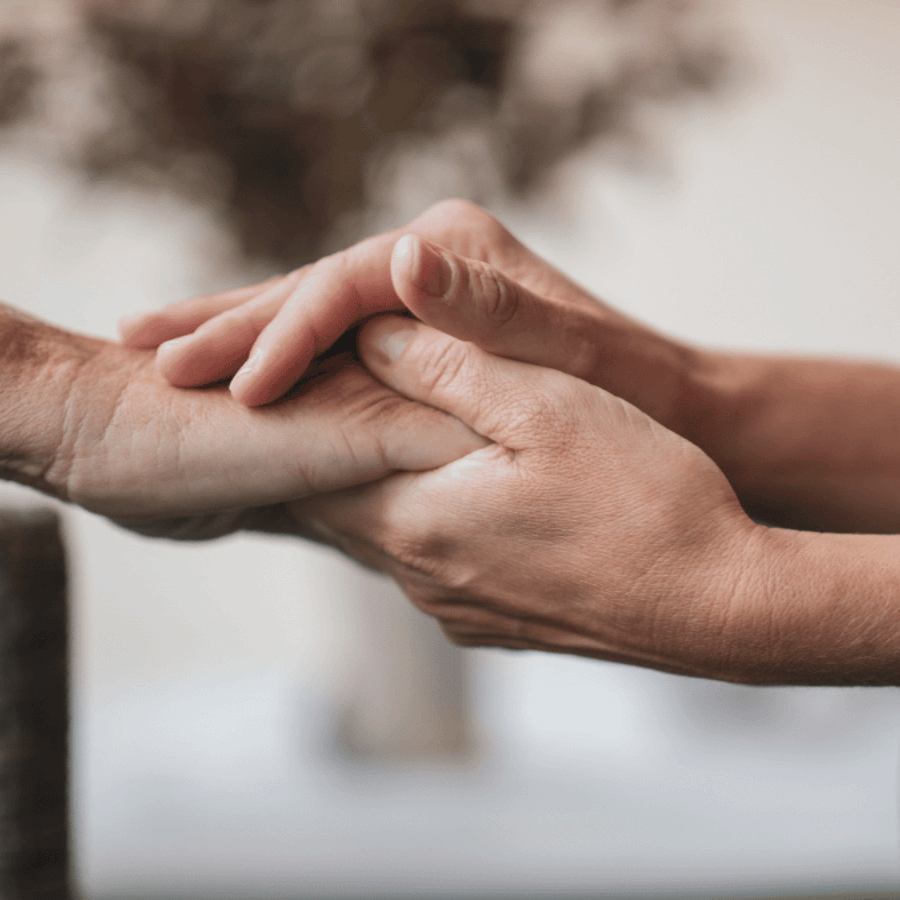 one hand holding another in support