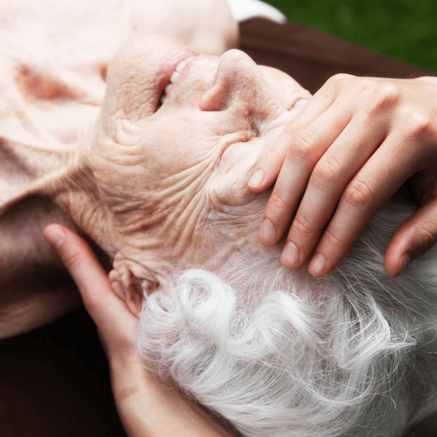 old woman getting a massage on her head