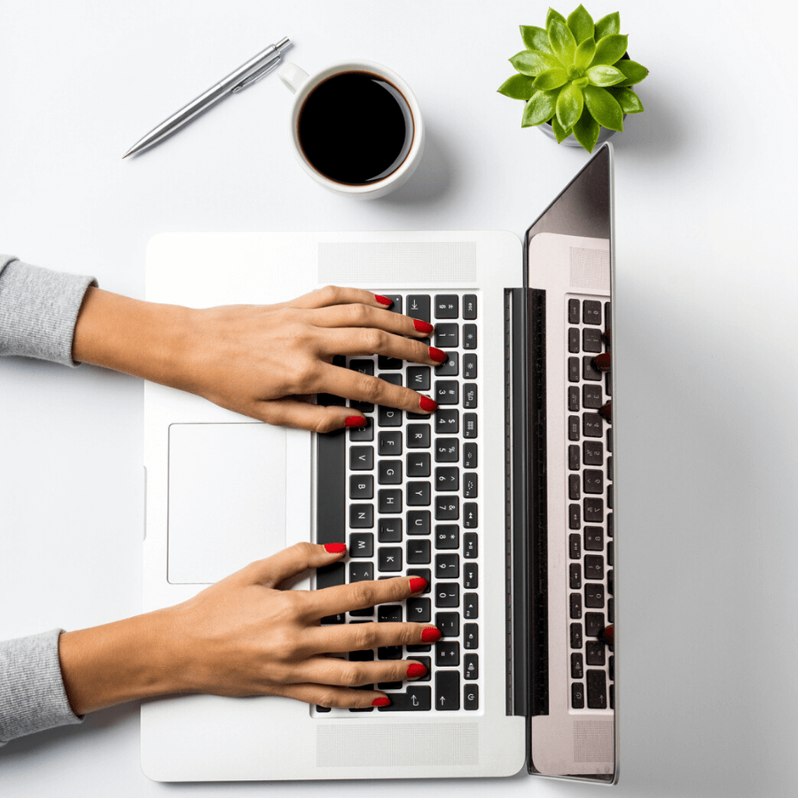 hands typing on laptop