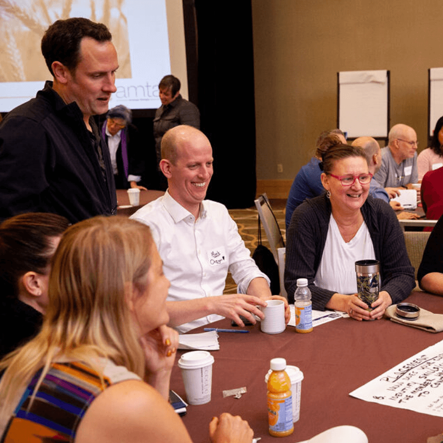 attendees meeting a round table at AMTA National Convention