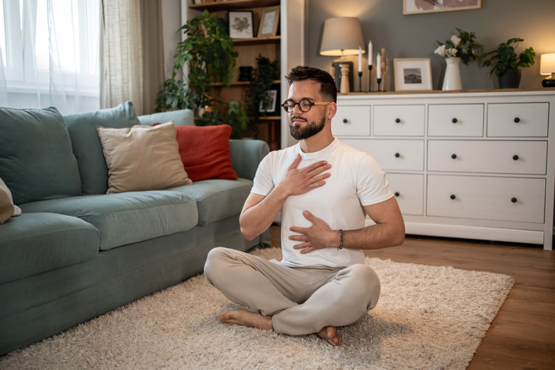 man taking a deep breath in seated position
