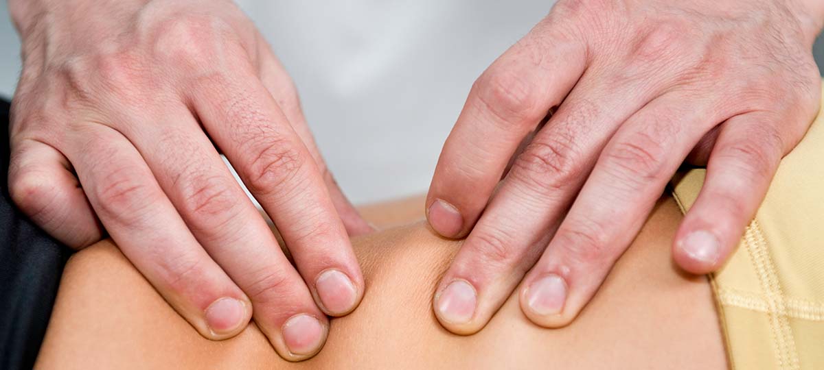 Close up of hands on back rolling skin