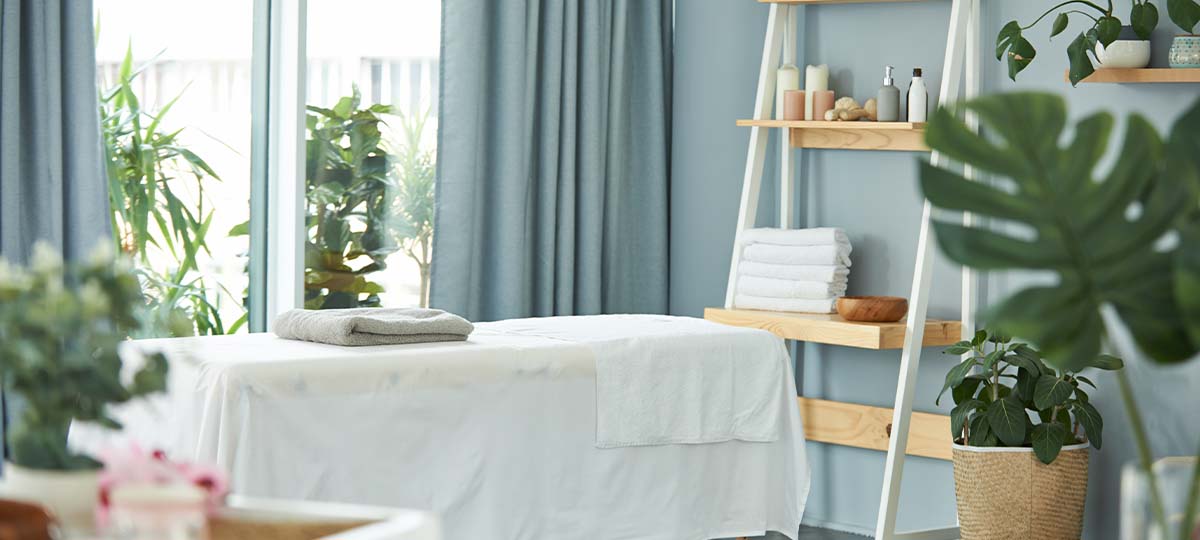 Massage room with table and tropical plants