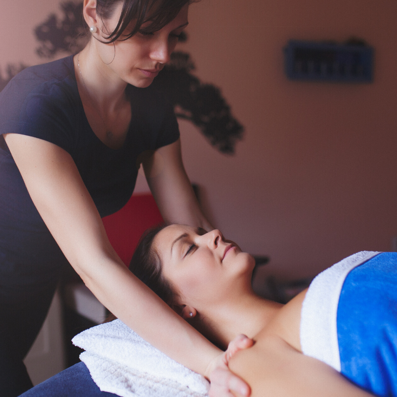 massage therapist massaging client's shoulders