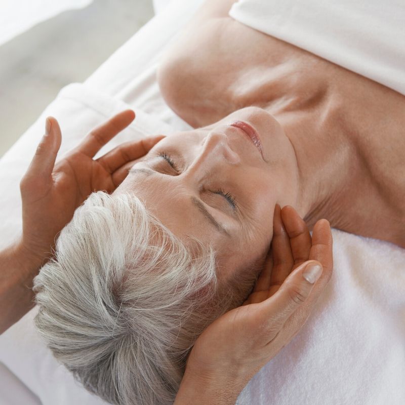 hands massaging woman's head