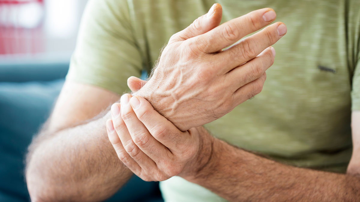 man massaging his painful wrist