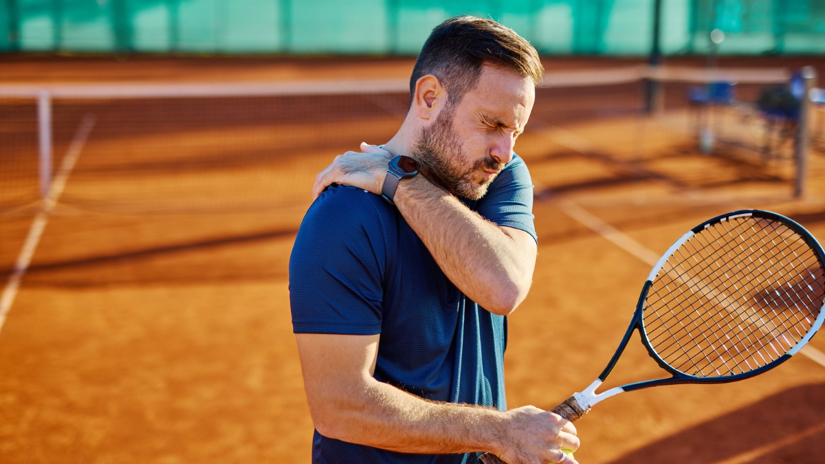 man playing tennis with shoulder pain