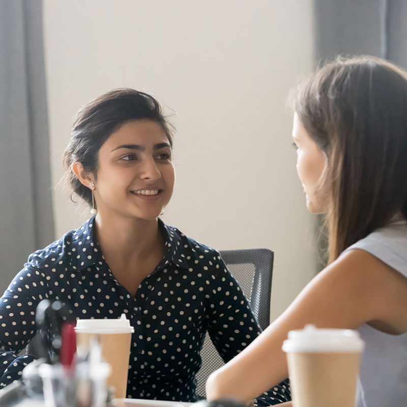 two women having coffee and talking