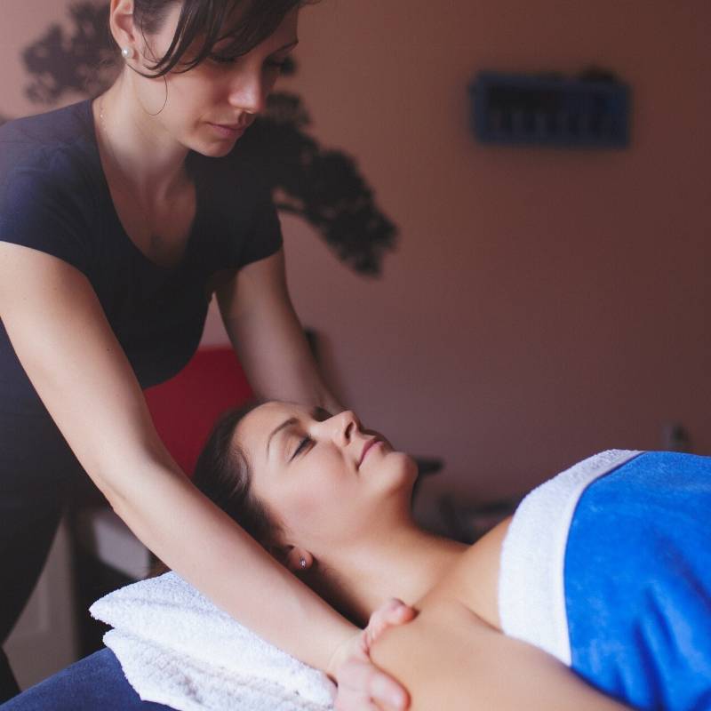 massage therapist massaging client's shoulders