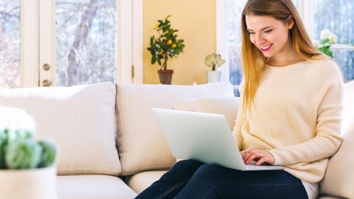 woman on a couch using a laptop 
